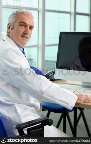 Doctor sat at computer