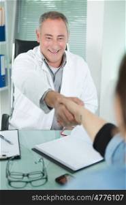 doctor shaking hands with a patient