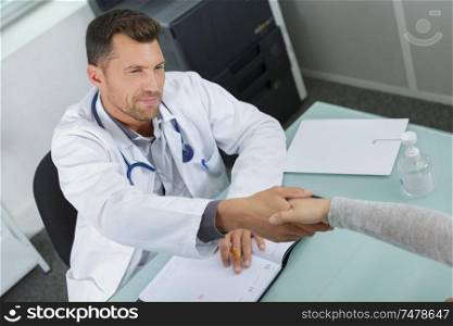 doctor shaking hands with a patient