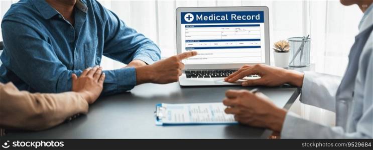 Doctor show medical diagnosis report on laptop and providing compassionate healthcare consultation while young couple patient holding hand and support each other in doctor clinic office. Neoteric. Doctor show medical diagnosis report on laptop to young couple. Neoteric