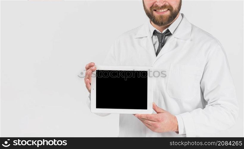 doctor showing tablet smiling