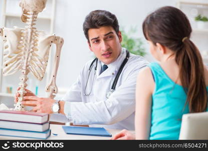 Doctor showing type of injury on skeleton to patient