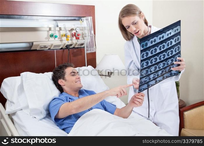 Doctor showing X-ray report to the smiling patient