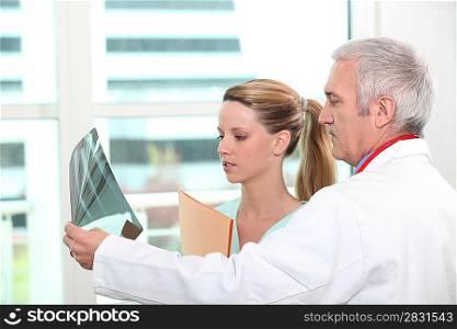 doctor showing x-ray to a nurse