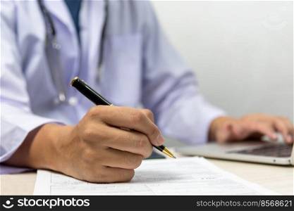 Doctor signs the patient paperwork at the desk.health care and insurance concept.
