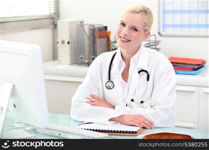 Doctor sitting behind her desk