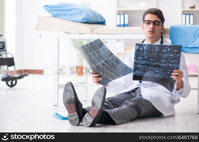 Doctor sitting on the floor in hospital