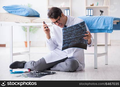 Doctor sitting on the floor in hospital