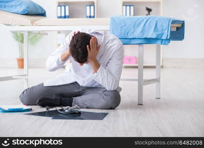 Doctor sitting on the floor in hospital