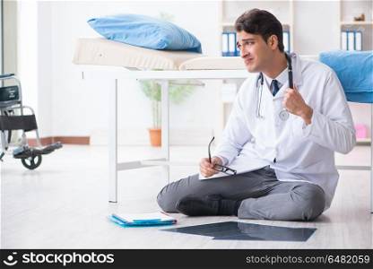 Doctor sitting on the floor in hospital