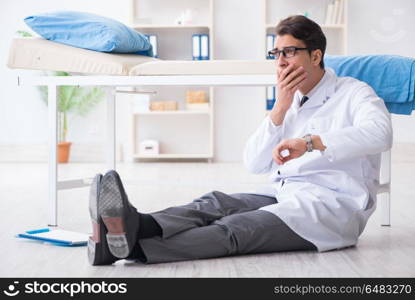 Doctor sitting on the floor in hospital