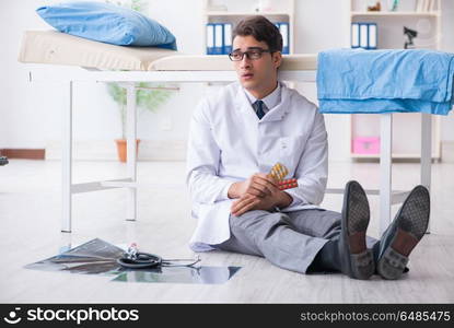 Doctor sitting on the floor in hospital