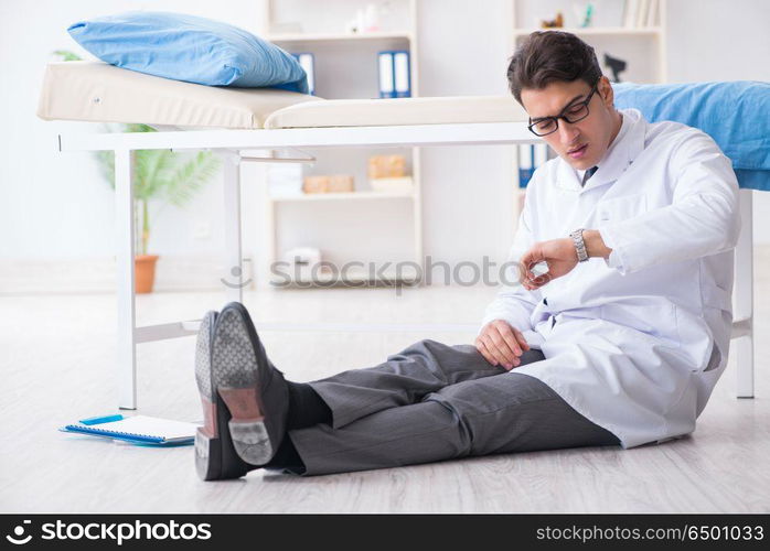 Doctor sitting on the floor in hospital