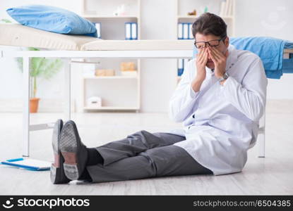 Doctor sitting on the floor in hospital