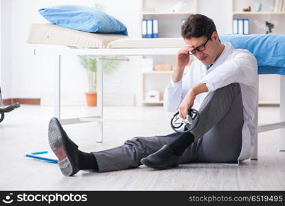 Doctor sitting on the floor in hospital