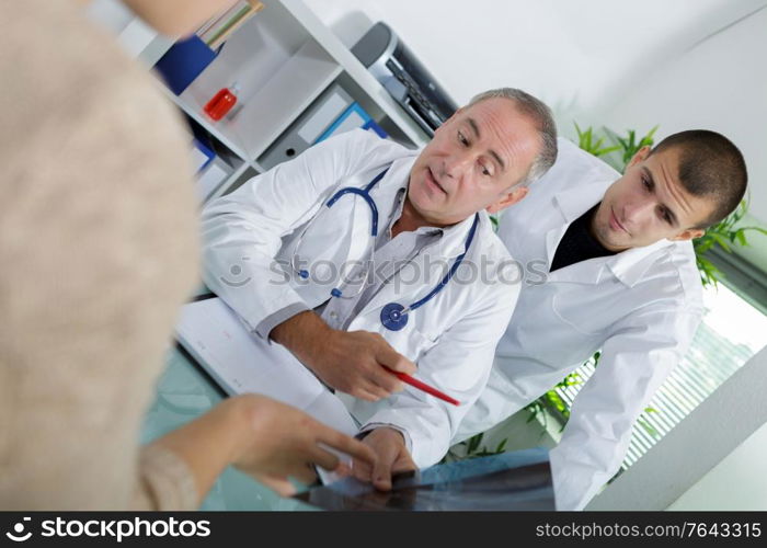 doctor sitting with male patient at the desk