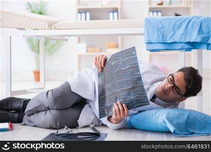 Doctor sleeping on floor after long night shift