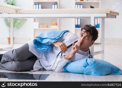 Doctor sleeping on floor after long night shift