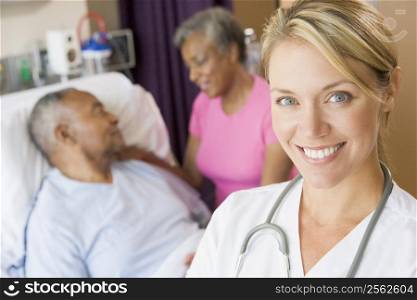 Doctor Smiling,Standing In Patients Room