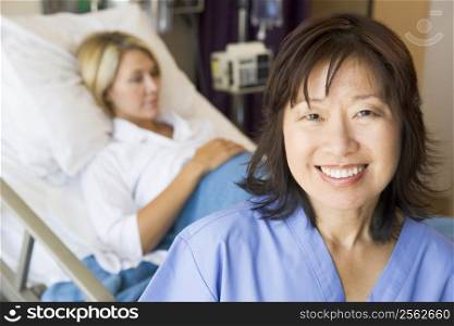 Doctor Standing In Patients Room,Smiling