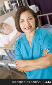 Doctor Standing With Arms Crossed In Her Patients Room