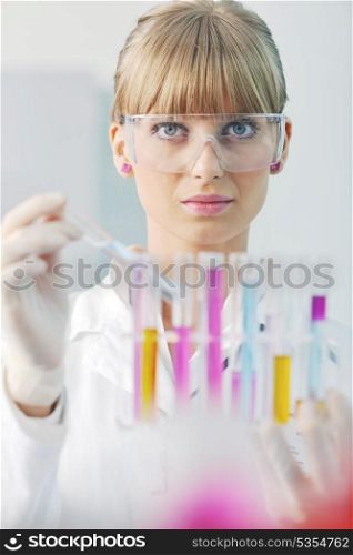 doctor student female researcher holding up a test tube in chemistry bright labaratory