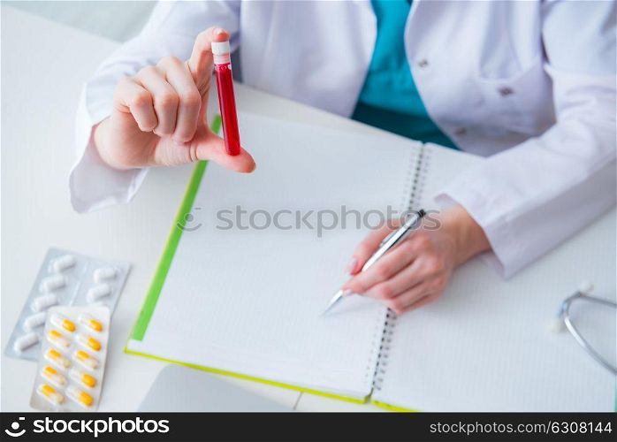 Doctor studying tube of blood in medical concept. The doctor studying tube of blood in medical concept