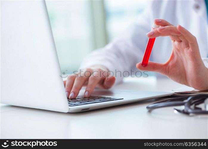 Doctor studying tube of blood in medical concept