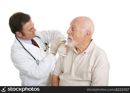 Doctor taking a senior man&rsquo;s temperature during a routine physical. Isolated on white.