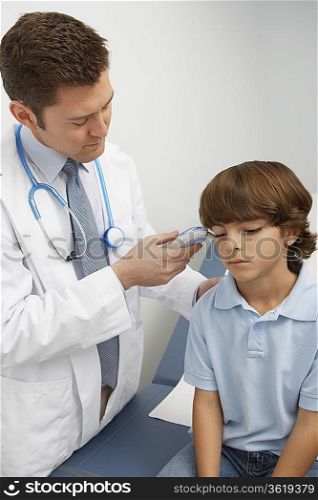 Doctor taking boys temperature