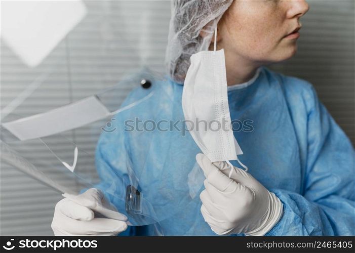 doctor taking off her face mask