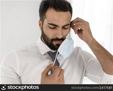 doctor taking off his medical mask