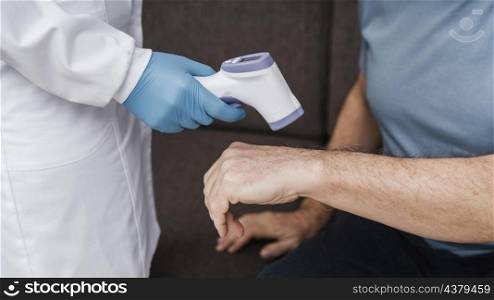 doctor taking patients temperature