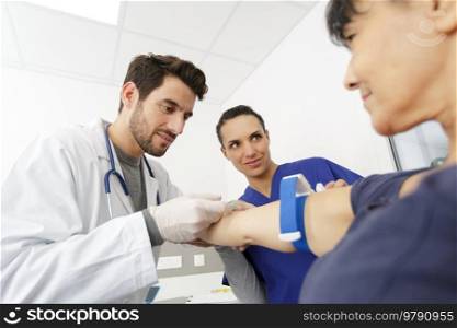 doctor taking pulse of the patient