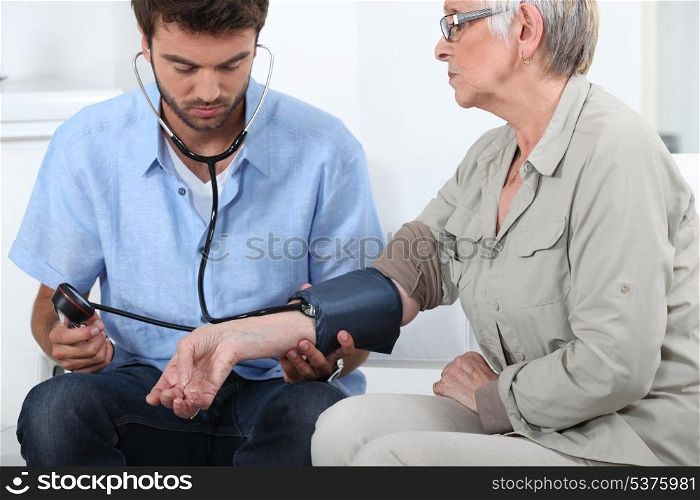 Doctor taking the blood pressure
