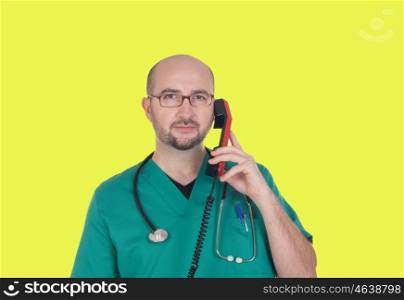 Doctor talking on telephone on a yellow background