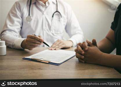 Doctor talking to a senior patient in a clinic.