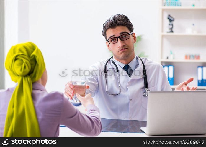 Doctor talking to cancer patient in hospital