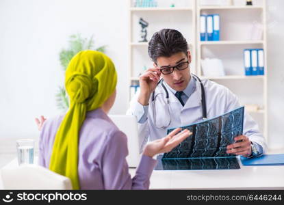 Doctor talking to cancer patient in hospital