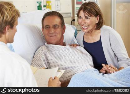 Doctor Talking To Couple On Ward