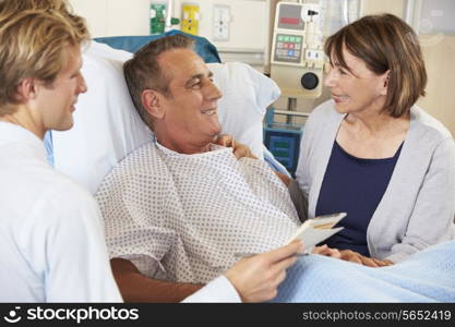 Doctor Talking To Couple On Ward