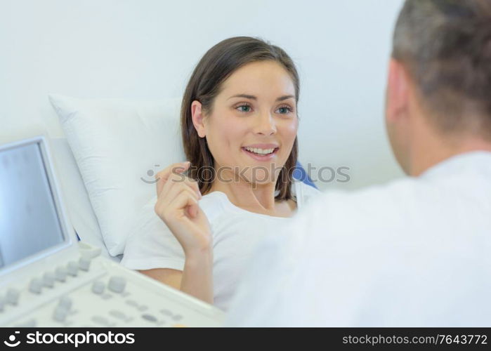 doctor talking to happy pregnant patient