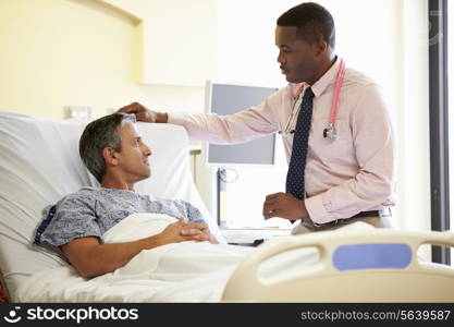 Doctor Talking To Male Patient In Hospital Room