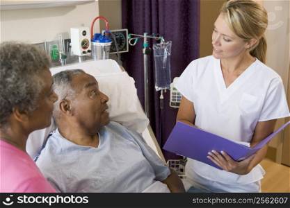 Doctor Talking To Senior Couples,Making Notes