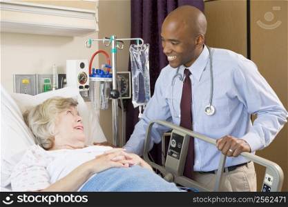 Doctor Talking To Senior Woman Lying In Hospital Bed