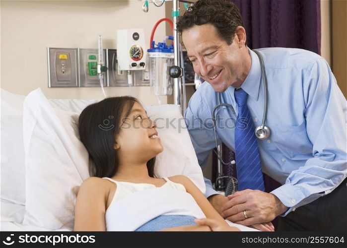 Doctor Talking To Young Girl In Hospital