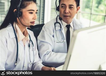 Doctor team wearing headset talking actively on video call in hospital clinic . Concept of telehealth and telemedicine service .. Doctor team wearing headset talking actively on video call in hospital clinic