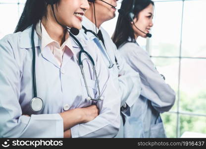 Doctor team wearing headset talking actively on video call in hospital clinic . Concept of telehealth and telemedicine service .. Doctor team wearing headset talking actively on video call in hospital clinic