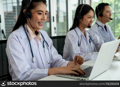 Doctor team wearing headset talking actively on video call in hospital clinic . Concept of telehealth and telemedicine service .. Doctor team wearing headset talking actively on video call in hospital clinic