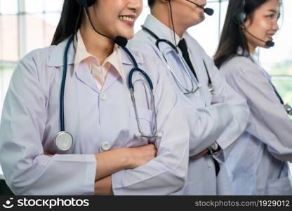 Doctor team wearing headset talking actively on video call in hospital clinic . Concept of telehealth and telemedicine service .. Doctor team wearing headset talking actively on video call in hospital clinic